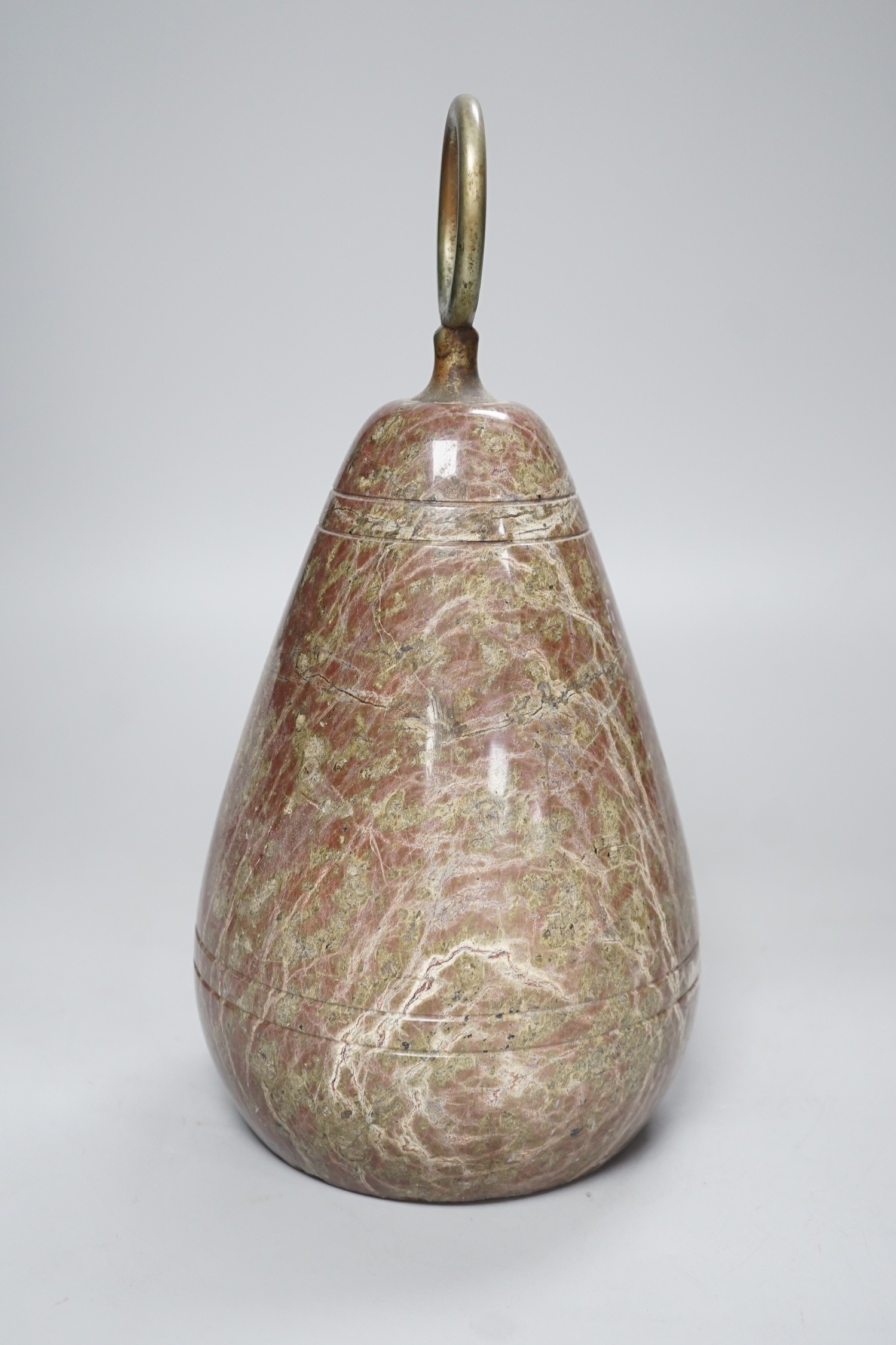 A polished serpentine doorstop. 21cm tall